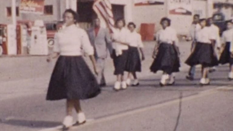 image: 1958 Hawkins Colored High School marching in Jarvis College homecoming parade, downtown Hawkins, TX